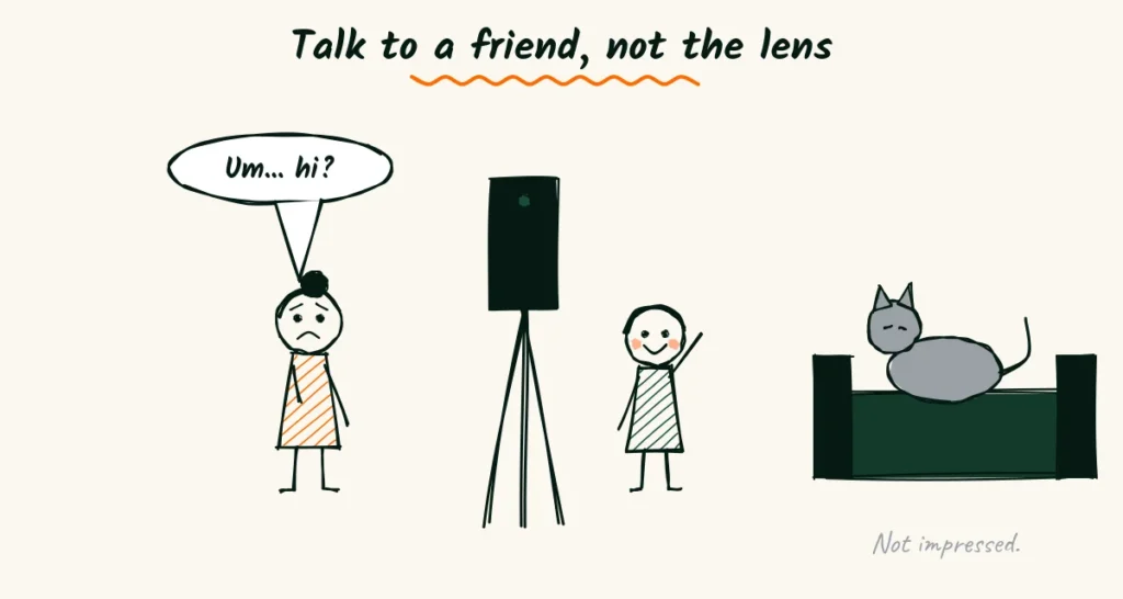 Tips for camera-shy photographers A nervous photographer saying um, hi to a friend standing beside a phone on a tripod, while a grey cat on a sofa looks unimpressed