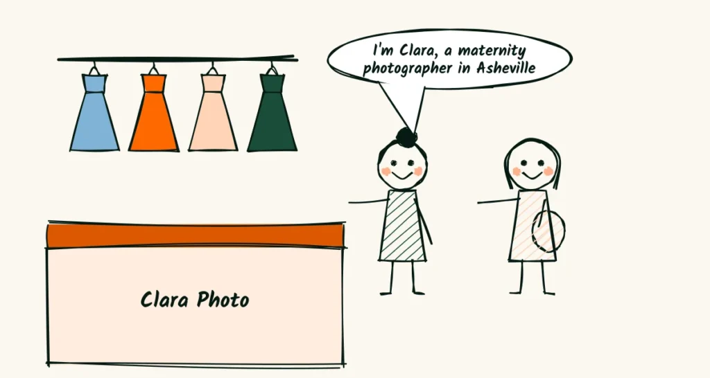 A spoken business introduction A doodle photographer at a baby fair stall with a gown rail behind her, greeting a pregnant visitor, with a speech bubble that says I am Clara, a maternity photographer in Asheville